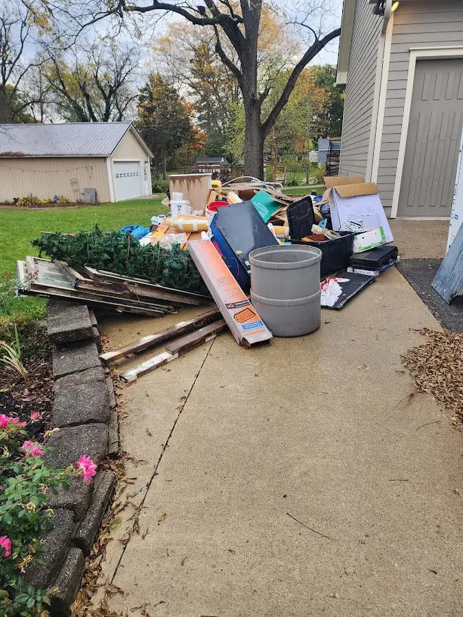 Dumpster being loaded with debris for 12 Yard Dumpster Rental in Latrobe